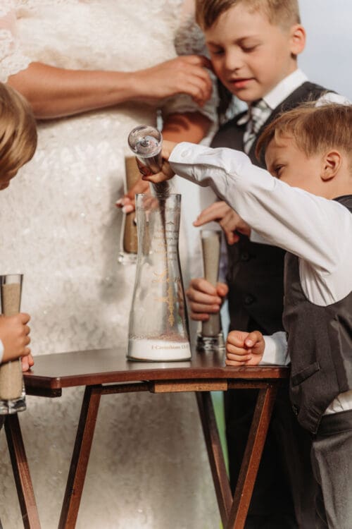 Children taking part in a unity sand ceremony during an anniversary vow renewal in the Blue Ridge Mountains.