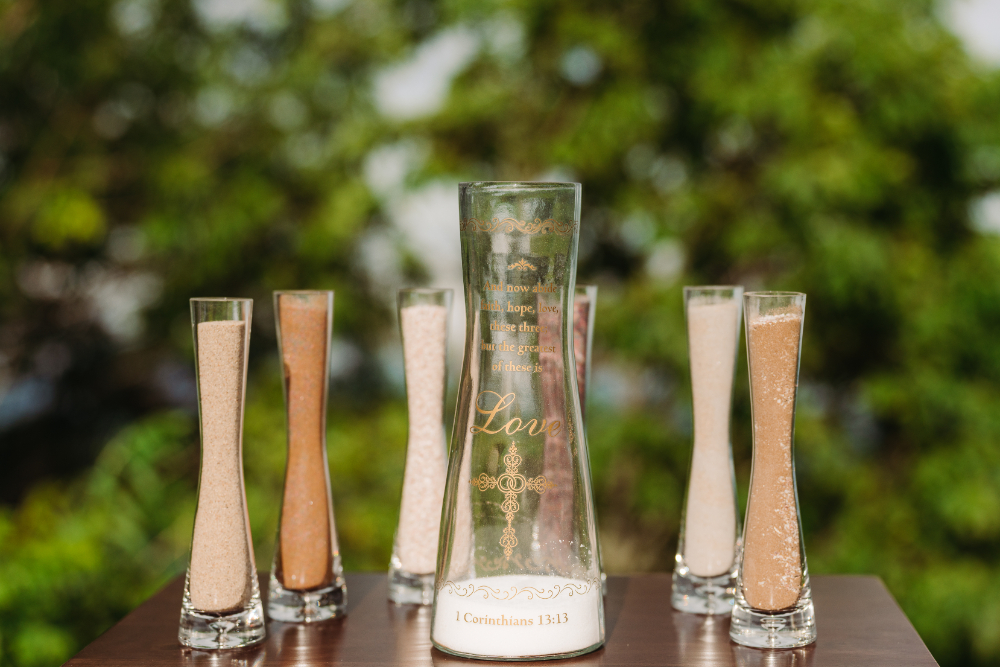 Unity sand ceremony during an anniversary vow renewal in the Blue Ridge Mountains with engraved keepsake vase.