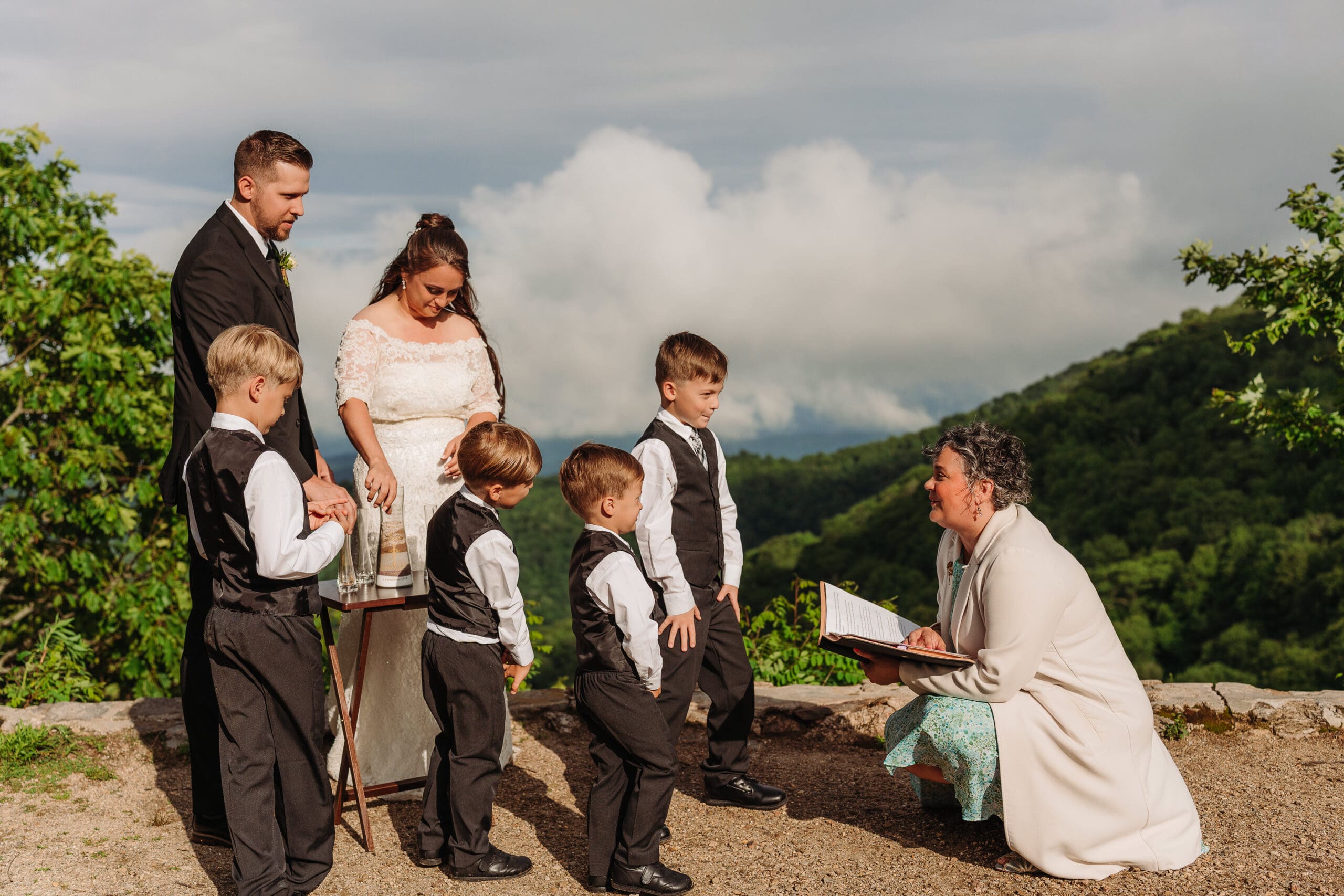 Officiant leading a personalized mountain elopement ceremony with the couple and their children