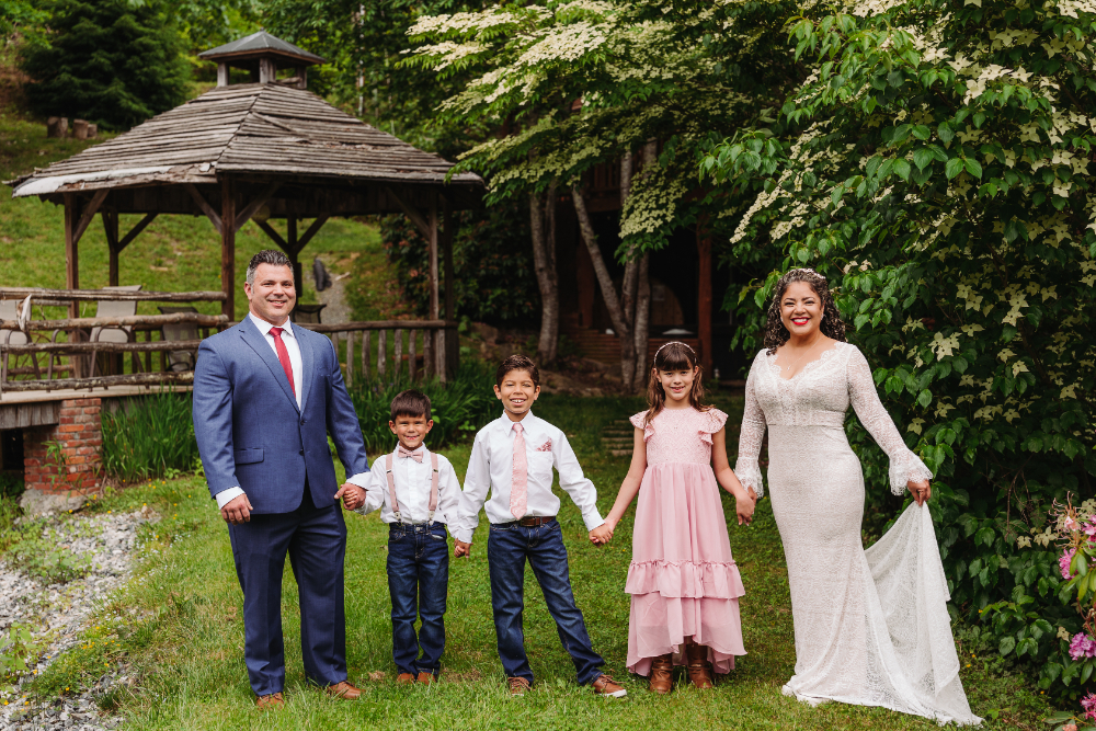 Family standing together at an outdoor mountain elopement while enjoying a day of hiking with kids.