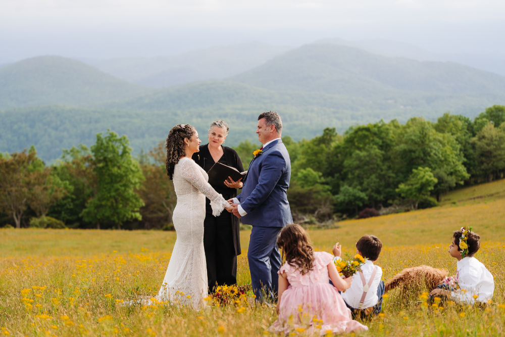 Couple exchanging vows with mountain views during a family elopement focused on hiking with kids.