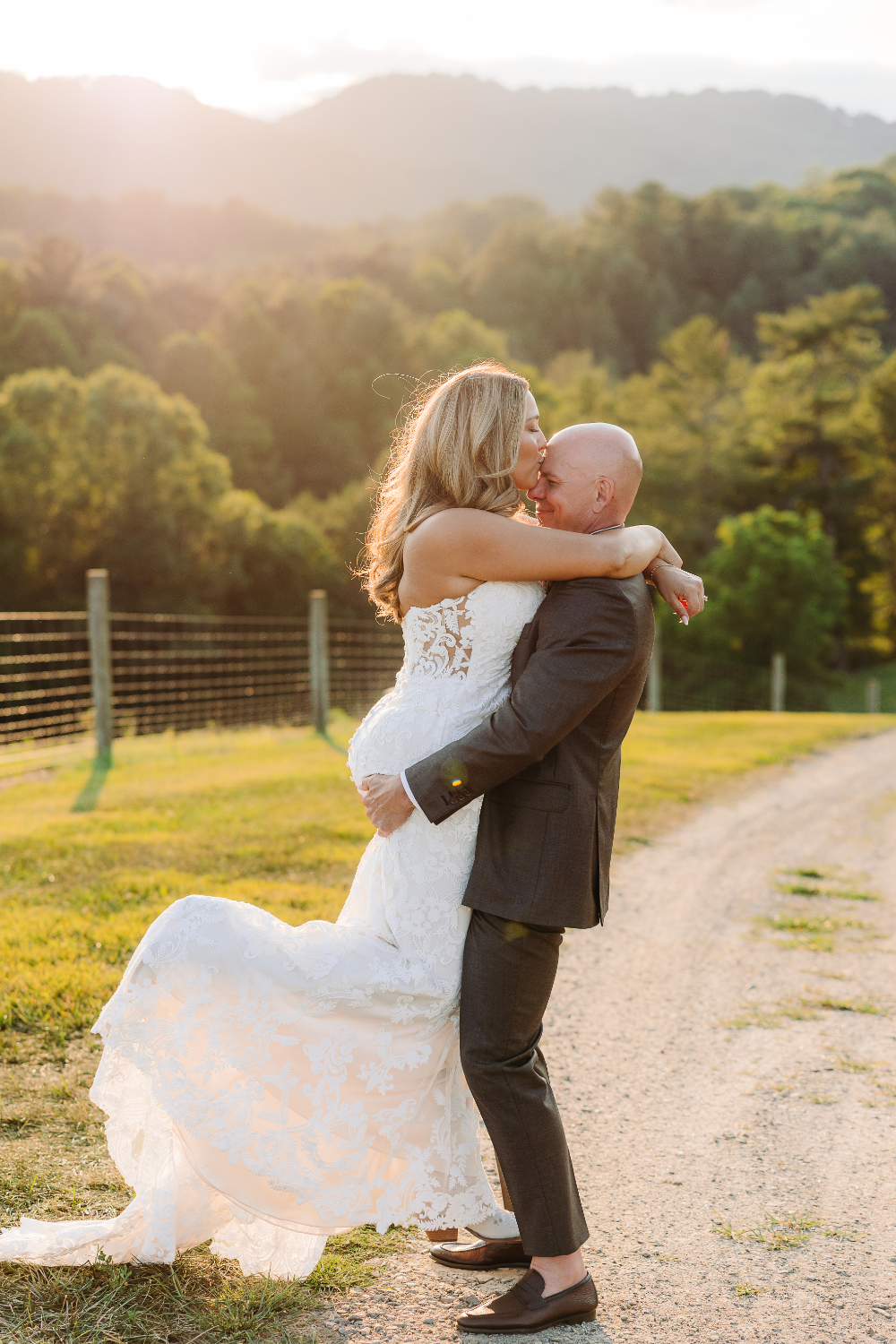 Bride and groom sharing a joyful embrace outdoors, inspiring romantic second wedding ideas in the mountains.