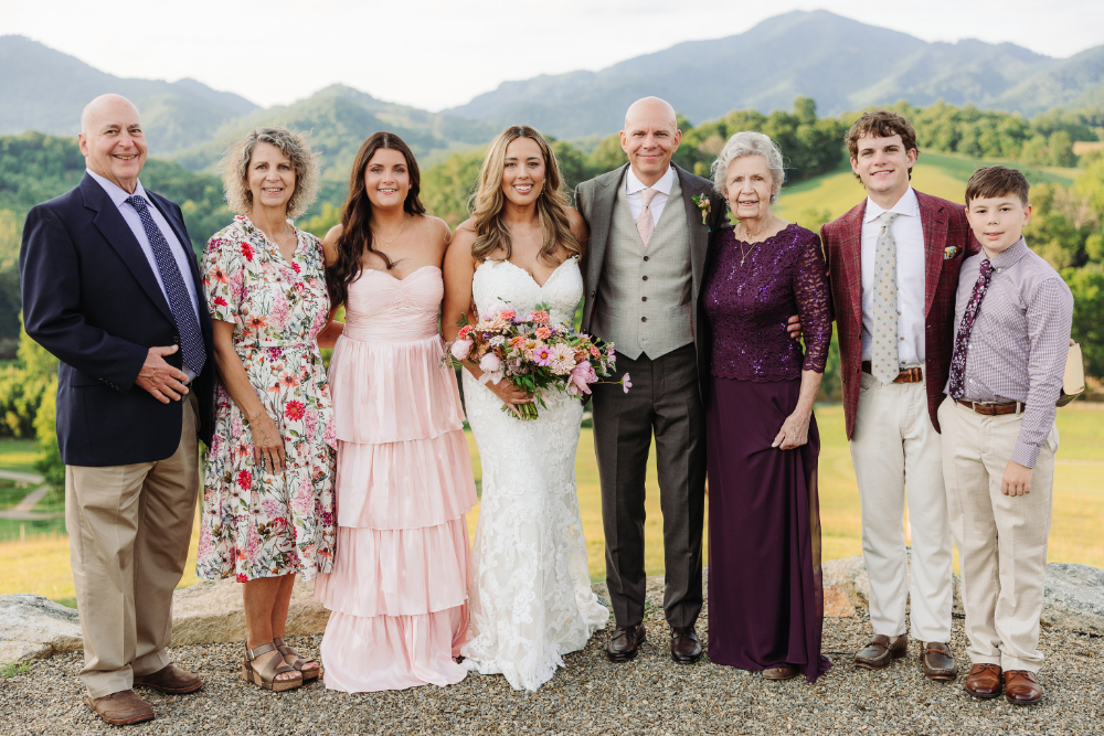 Couple celebrating with their blended family outdoors, offering heartfelt second wedding ideas for families.
